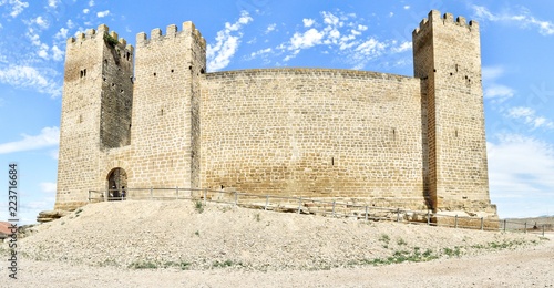 The middle ages stone made ancient castle Castillo de los Bañales, with towers and defensive merlons, in Sabada, a small typical rural town in the Aragon region, Spain photo