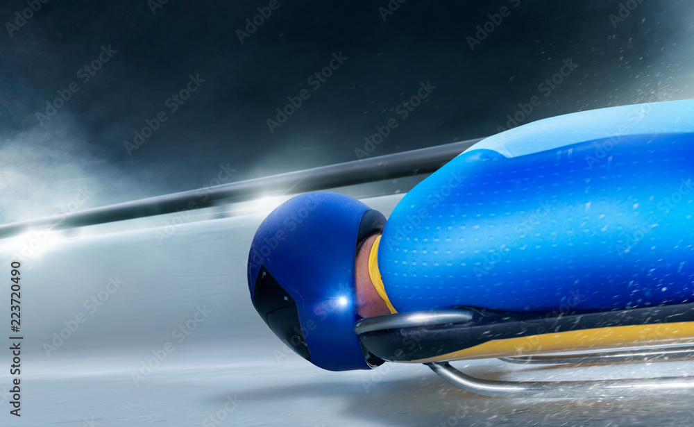 Skeleton sport. The athlete descends on a sleigh on an ice track. Winter sports. Bobsled. Luge Skeleton sport. The athlete descends on a sleigh on an ice track. Winter sports. Bobsled. Luge