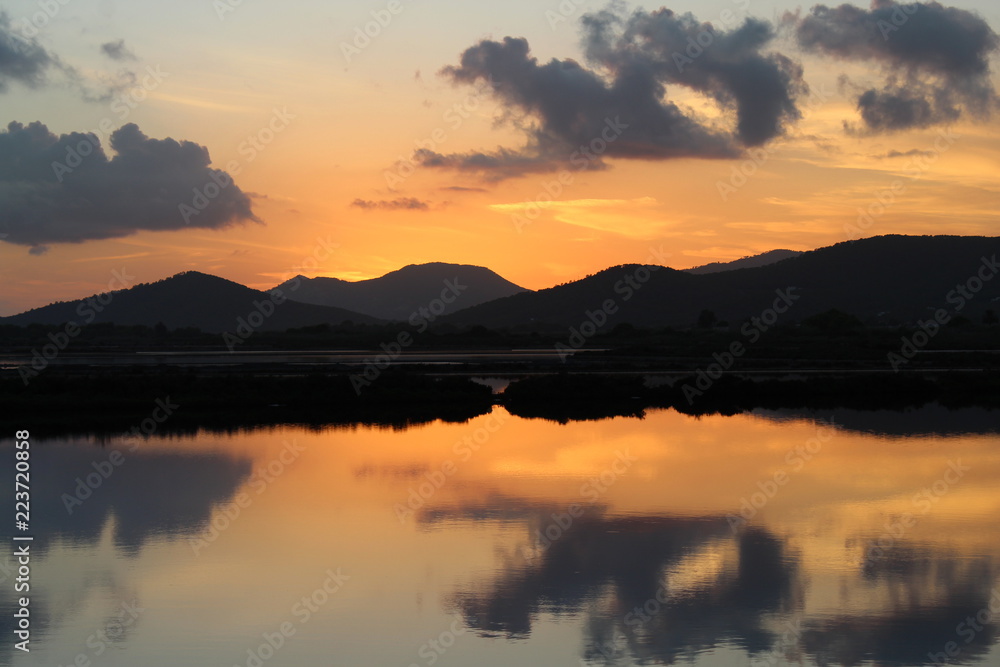 Sunset over water in ses salines, ibiza: water reflections
