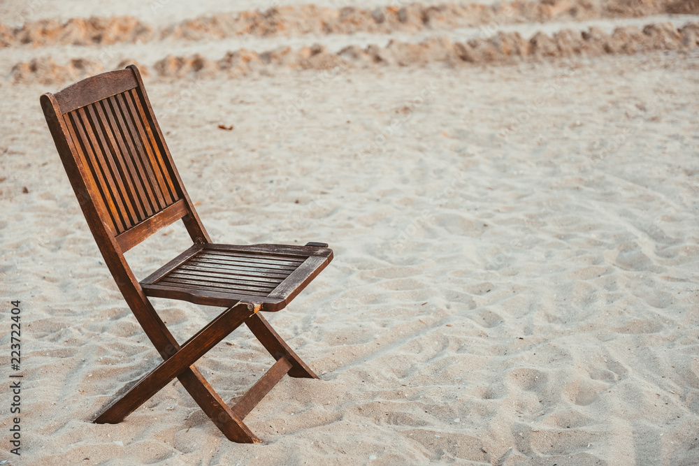 Beach wooden chair on the sand Beach wooden chair on the sand