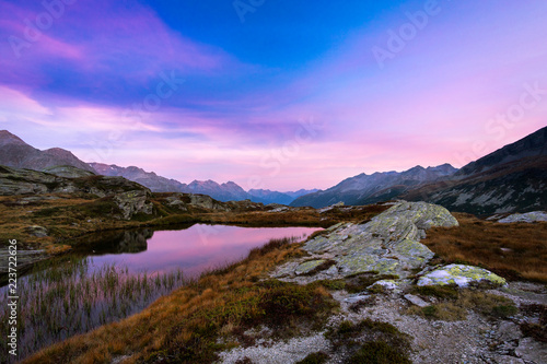 Fototapeta Naklejka Na Ścianę i Meble -  lake in mountains alps with cloudy sky at sunset