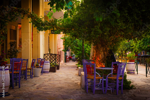 Mediteranean Coffee tables under a tree in Tisseo district of Athens in Greece © FarfallaPhotographie