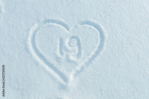 A figure of Nineteen written in the snow in the painted heart. Snow texture.