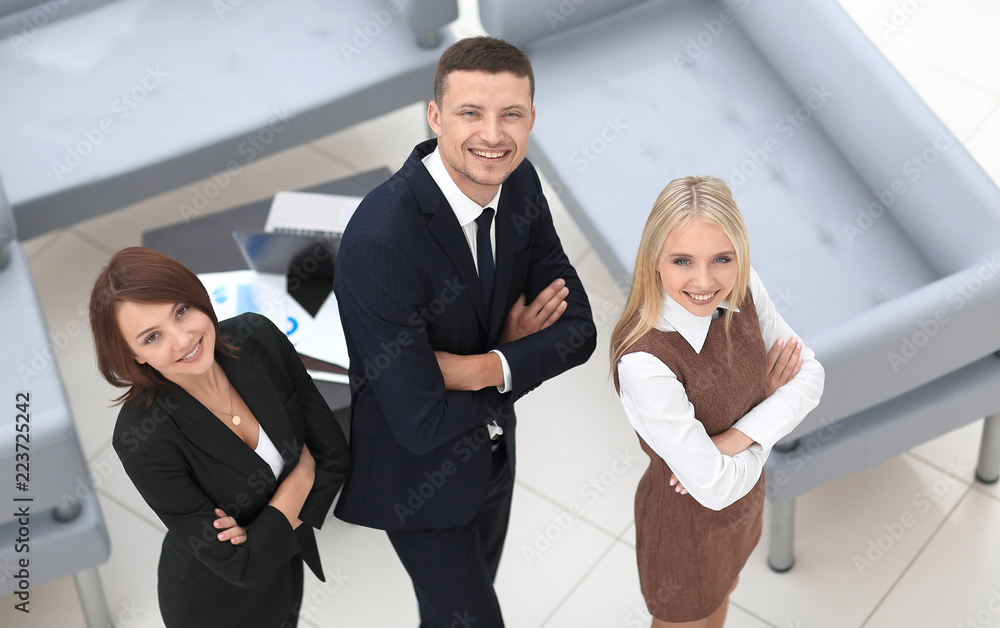 successful business team standing in office and looking at camera. successful business team standing in office and looking at camera.