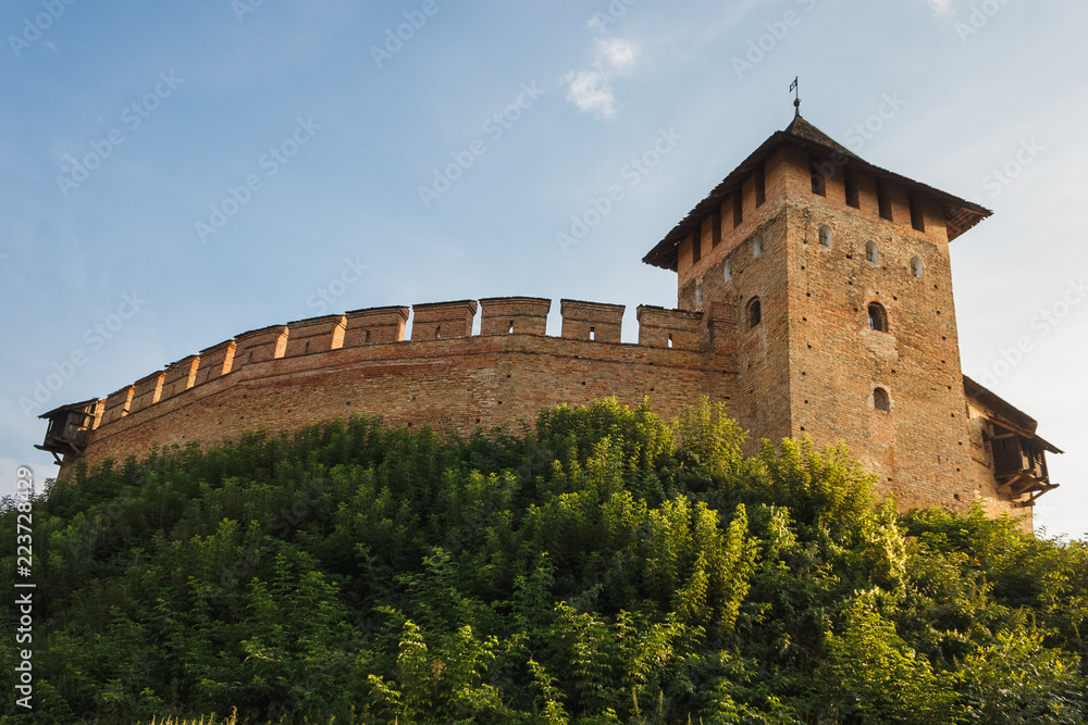 The medieval castle is illuminated by the sunset. Lutsk High Castle, also known as Lubart's Castle