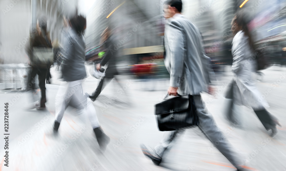 Obraz premium motion blurred business people walking on the street
