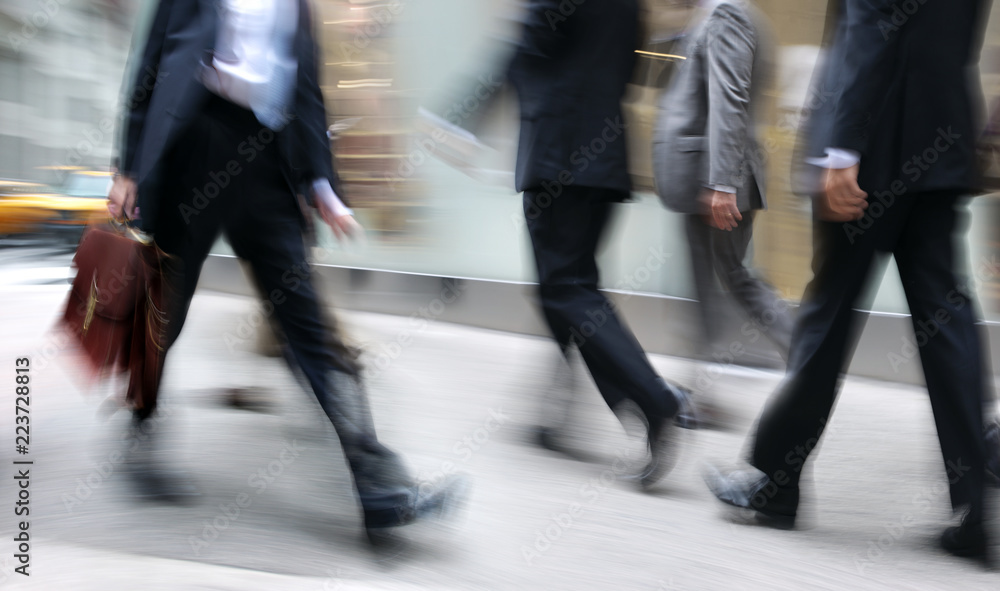motion blurred business people walking on the street motion blurred business people walking on the street