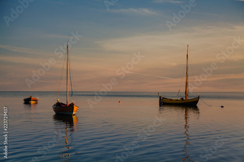Moored fishing boats in the bay. Sunset.