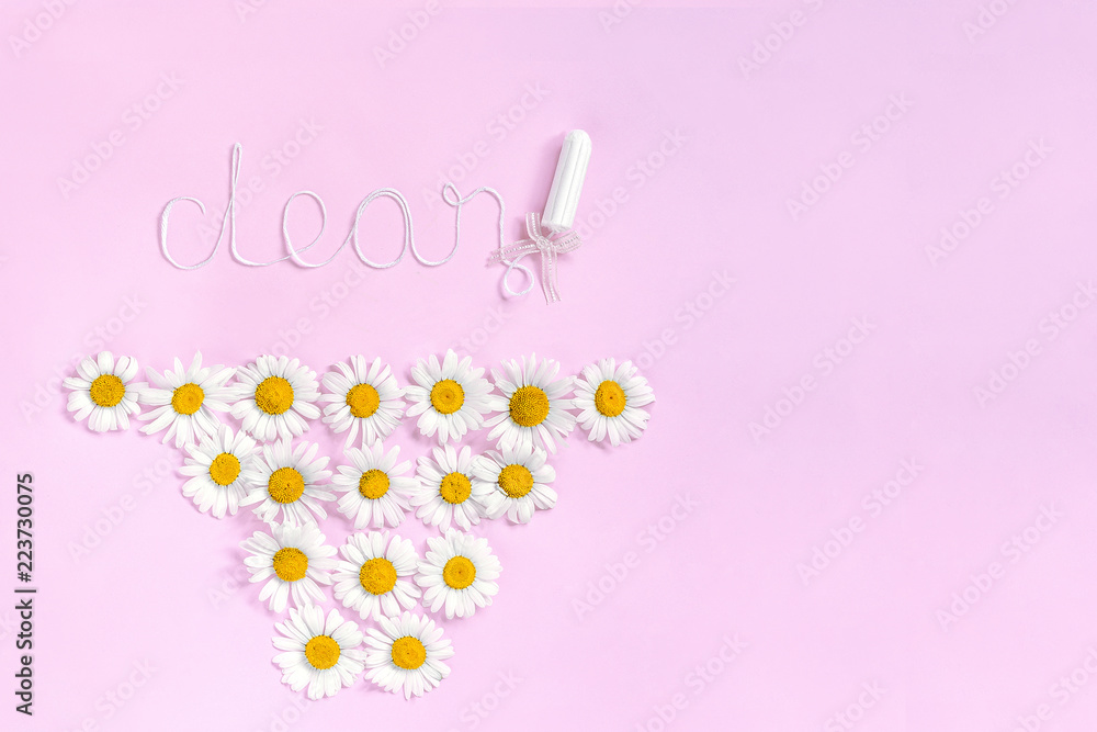 Word CLEAN from white thread hygienic female tampon and chamomile flowers in form panties on pink background. Concept hygiene health women and adolescents during menstrual cycle. Flat Lay, Copy space