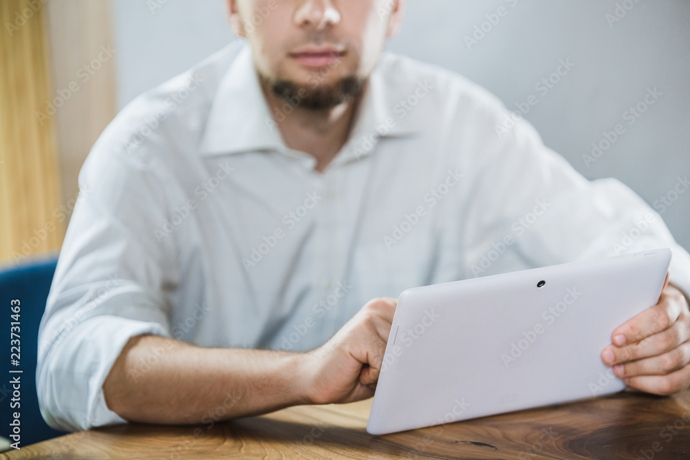 Man holds tablet. No face Man holds tablet. No face