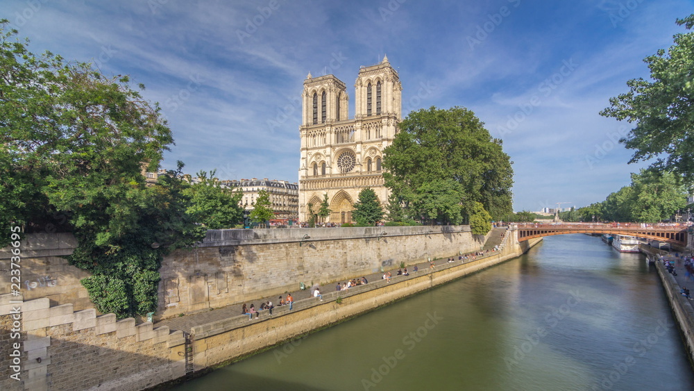 Front facade of cathedral of Notre Dame de Paris, with square full of people in front timelapse hyperlapse