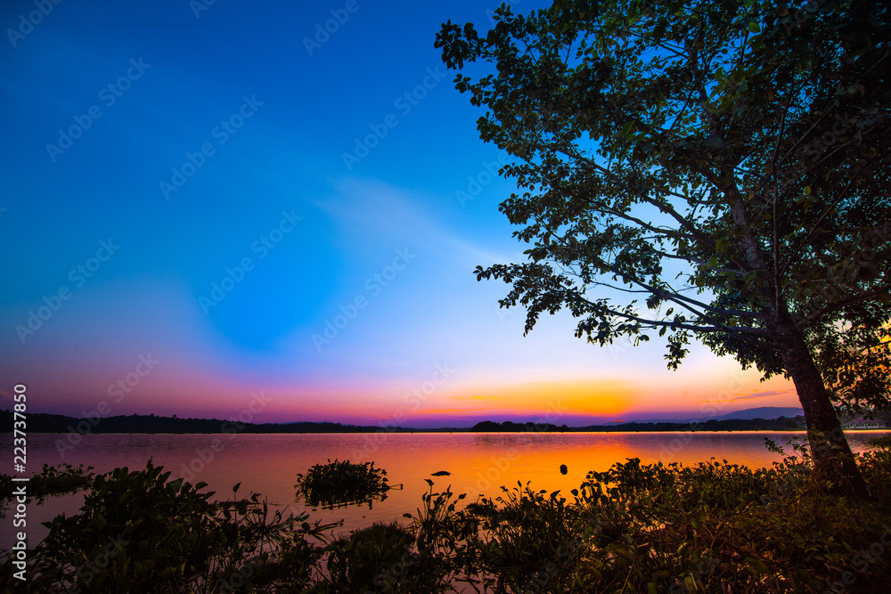 Beautiful blue twilight sky over clam lake at dawn for background