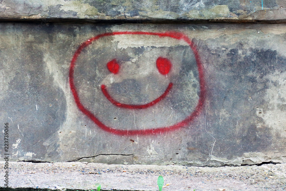 The abstract image of a smilie on a wall.