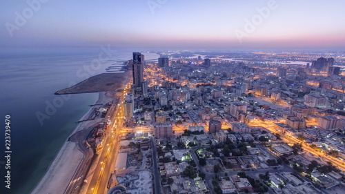 Fotografie, Tablou Cityscape of Ajman from rooftop night to day timelapse