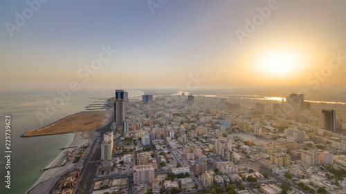 Sunrise and morning with Cityscape of Ajman from rooftop timelapse. Ajman is the capital of the emirate of Ajman in the United Arab Emirates. photo