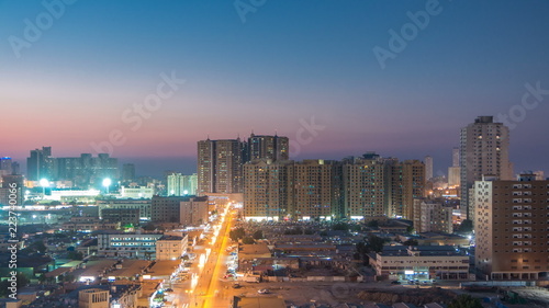 Cityscape of Ajman from rooftop day to night timelapse. Ajman is the capital of the emirate of Ajman in the United Arab Emirates. photo