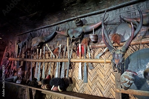 various animal skulls and armory, decoration for longhouse, Longwa, Nagaland, India