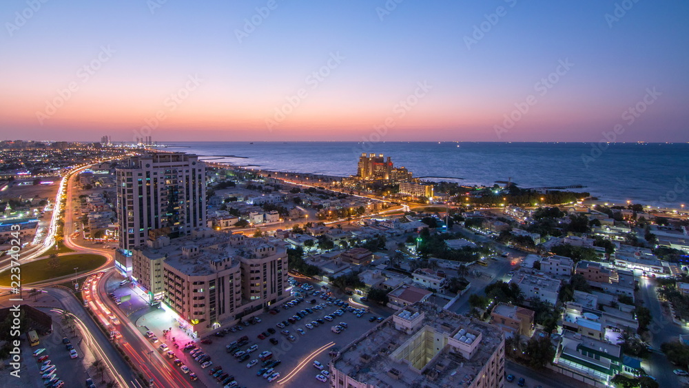 Citiscape of Ajman and Sharjah day to night timelapse from top