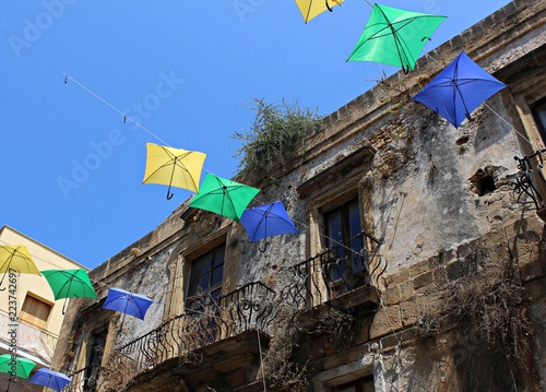 Italy, Sicily: Decorations with umbrellas on old house, during Sciacca Party.