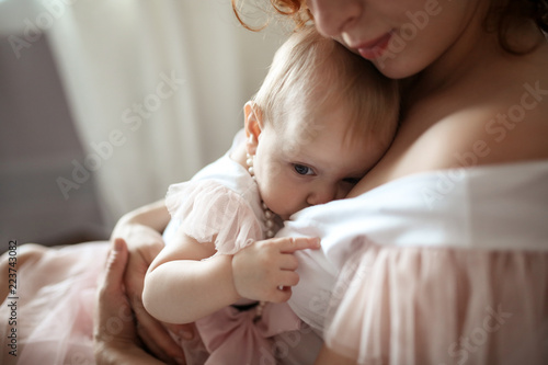 beautiful mother breastfeeding toddler daughter