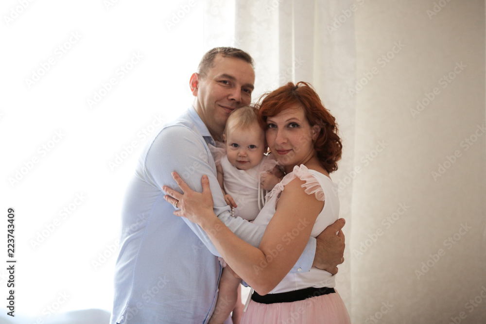 Fototapeta premium family with daughter toddler on hands in real