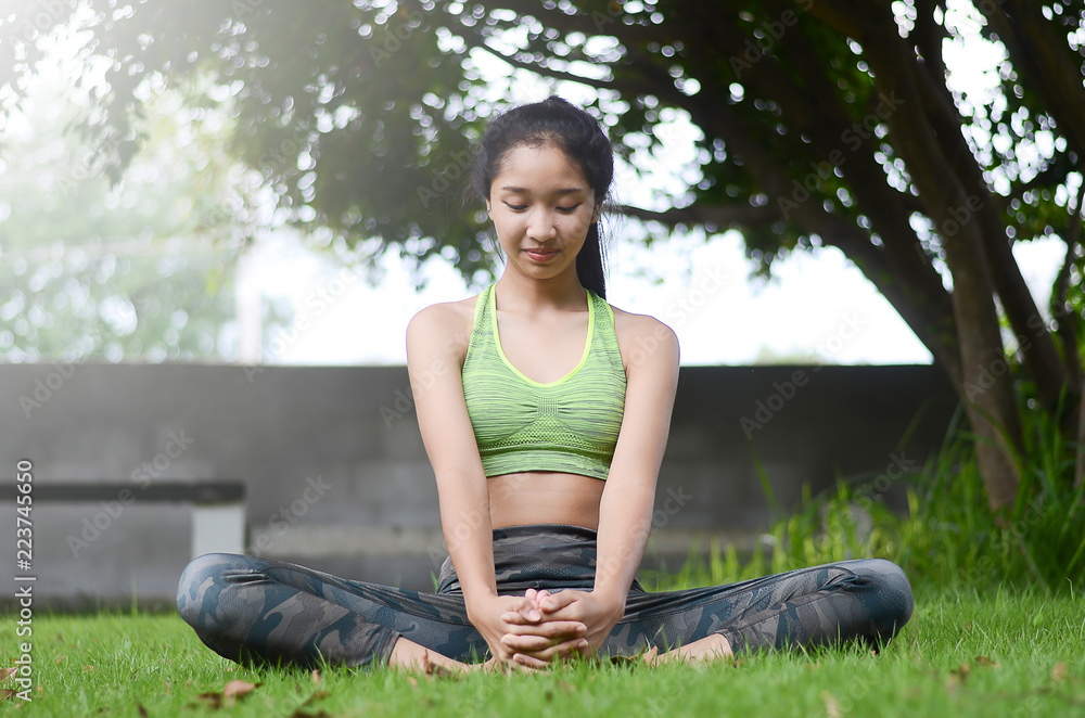 Teen Asian girls playing yoga in a public park