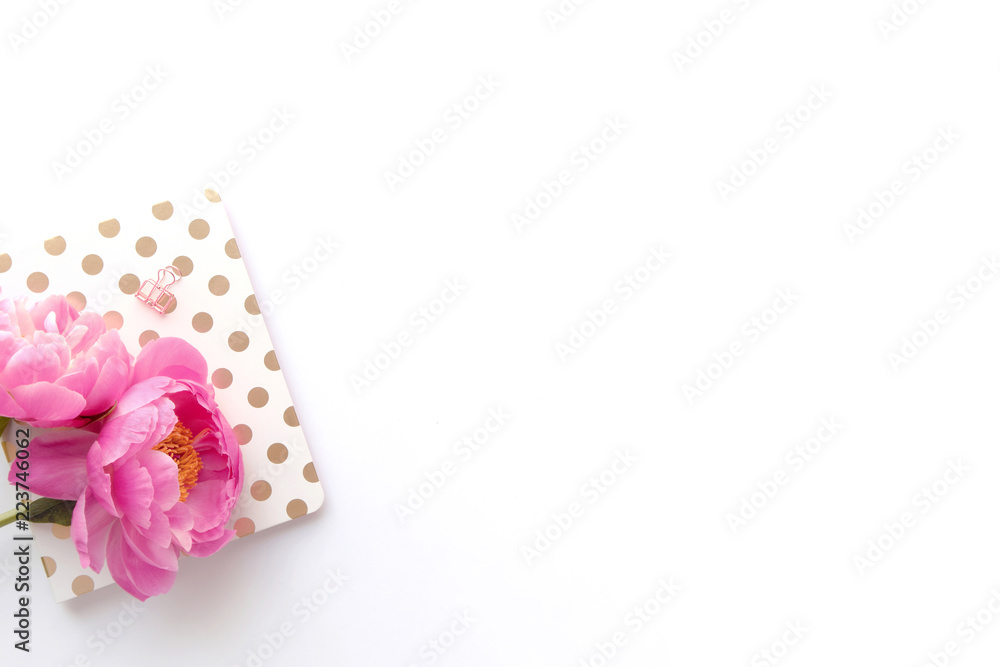 Styled flatlay - pink peonies, gold notebook, with white space / background Styled flatlay - pink peonies, gold notebook, with white space / background