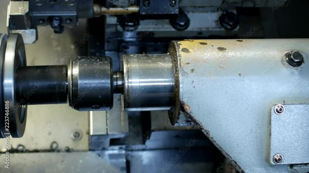 CNC lathe pulls out part of metal workpiece pulley, modern lathe for metal processing, close-up CNC lathe pulls out part of metal workpiece pulley, modern lathe for metal processing, close-up
