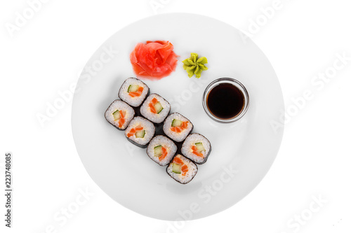Sushi, rolls, hosomaki, with salmon, avocado, cucumber and Philadelphia cheese, raw seafood, soy sauce, marinated ginger and wasabi on plate, white isolated background view from above For the menu