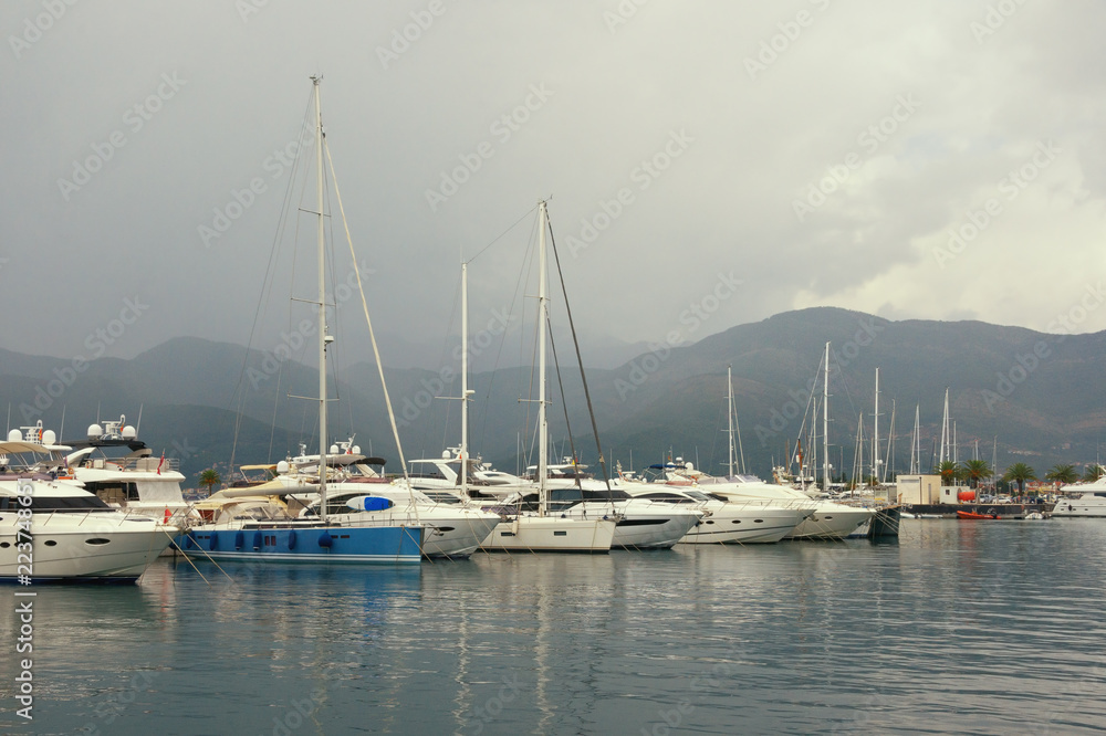 Misty Mediterranean landscape. Yachts in the fog.  Montenegro, Adriatic Sea, Bay of Kotor, Tivat city. View of yacht marina of Porto Montenegro