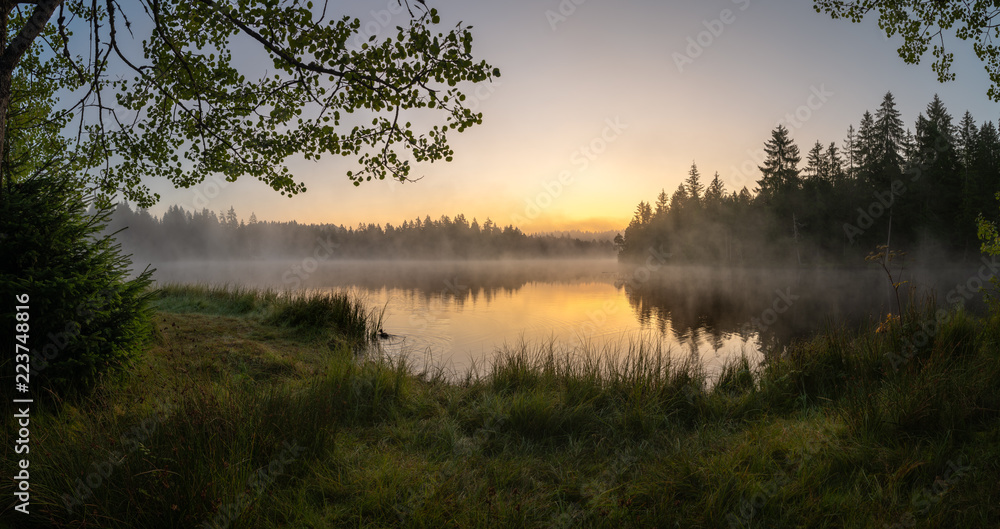Fototapeta premium Sunrise over beautiful moor in the franches montagnes. Misty fog over beautiful morning lake.