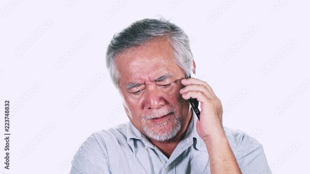 Upset Old man on phone isolated in white background. Talking on phone not happy. Asian male with white beard. Senior lifestyle concept. Upset Old man on phone isolated in white background. Talking on phone not happy. Asian male with white beard. Senior lifestyle concept.