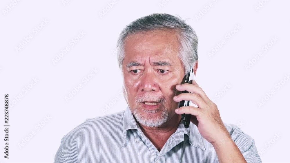 Upset Old man on phone isolated in white background. Talking on phone not happy. Asian male with white beard. Senior lifestyle concept. Upset Old man on phone isolated in white background. Talking on phone not happy. Asian male with white beard. Senior lifestyle concept.