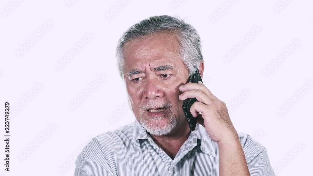 Upset Old man on phone isolated in white background. Talking on phone not happy. Asian male with white beard. Senior lifestyle concept. Upset Old man on phone isolated in white background. Talking on phone not happy. Asian male with white beard. Senior lifestyle concept.