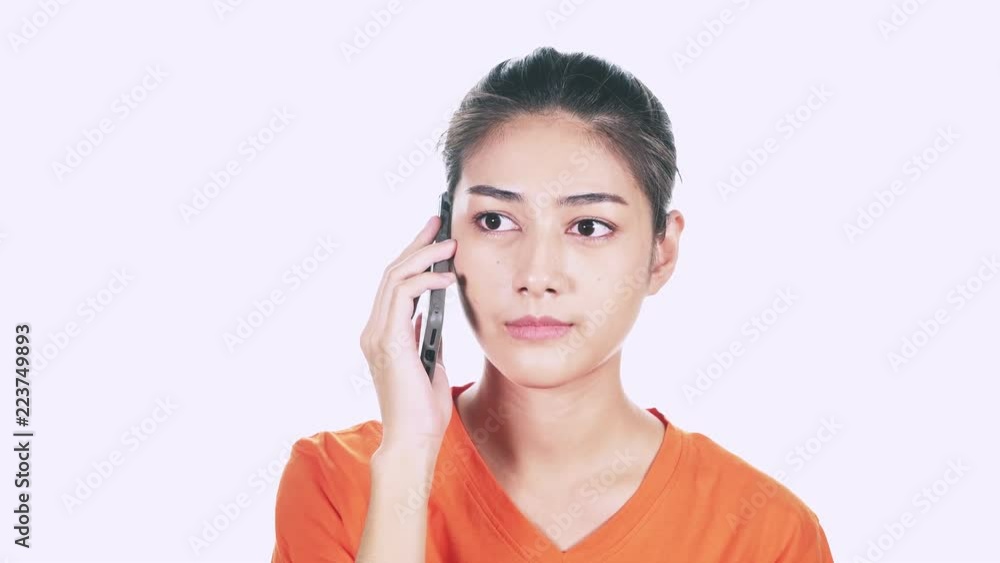 Young female hipster on phone talking, very upset. Asian woman talking on phone and angry with white background. Young female hipster on phone talking, very upset. Asian woman talking on phone and angry with white background.