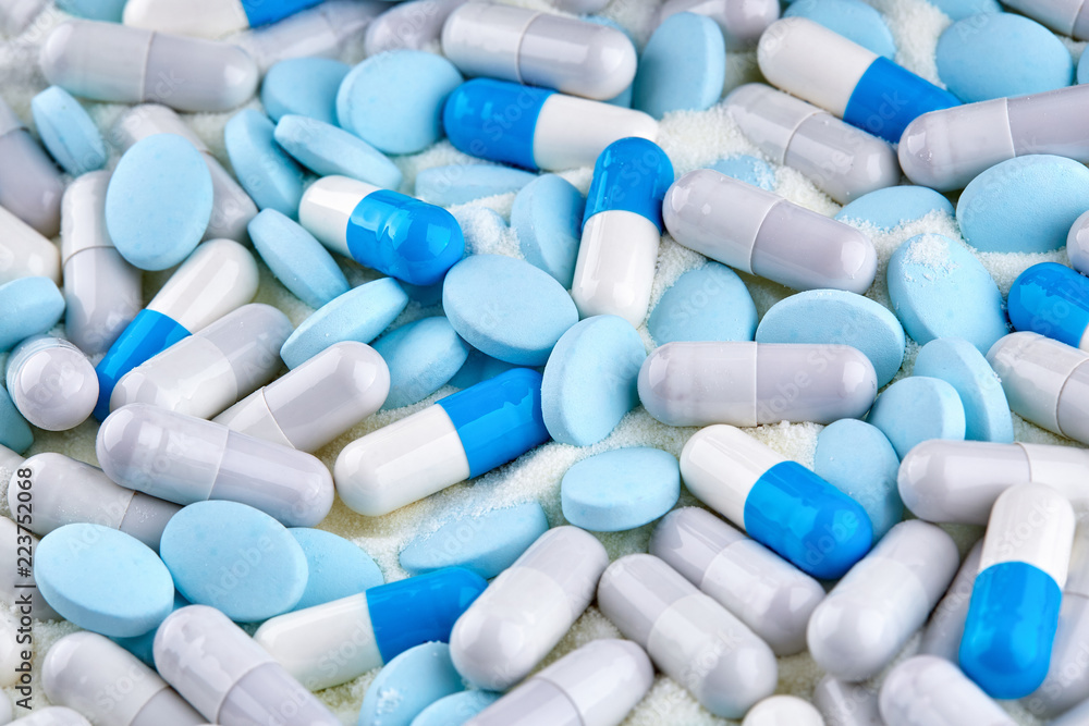 Many of blue capsules and tablets