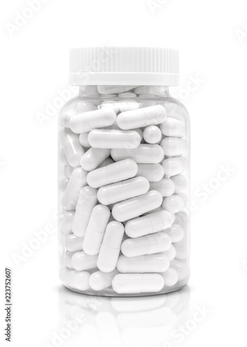 Fotografie white medicine or supplement capsules in transparent plastic bottle