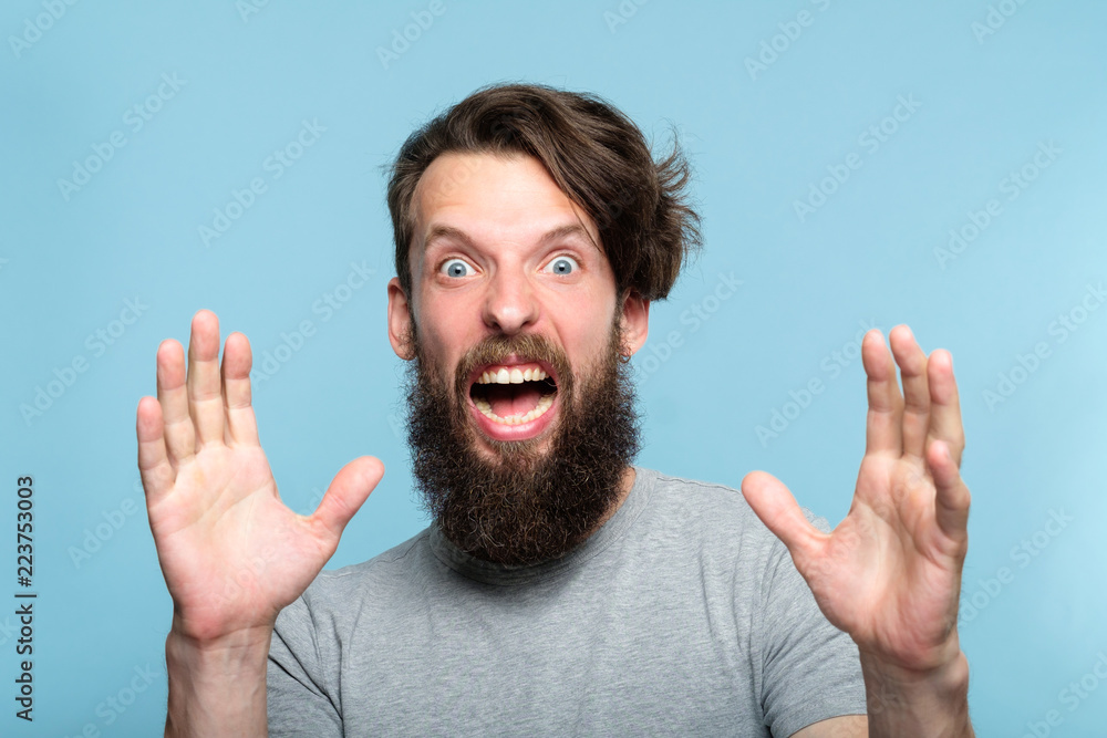 surprised startled terrified scared man screaming of fright with eyes surprised startled terrified scared man screaming of fright with eyes