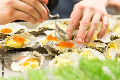A plate of Oysters in a restaurant kitchen with Caviar filling.