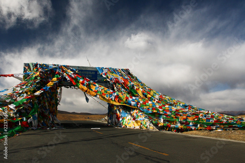 Dramatic sky over the prayer flag-covered Gyatso La pass, the highest point on the Friendship Highway between Nepal and Tibet photo