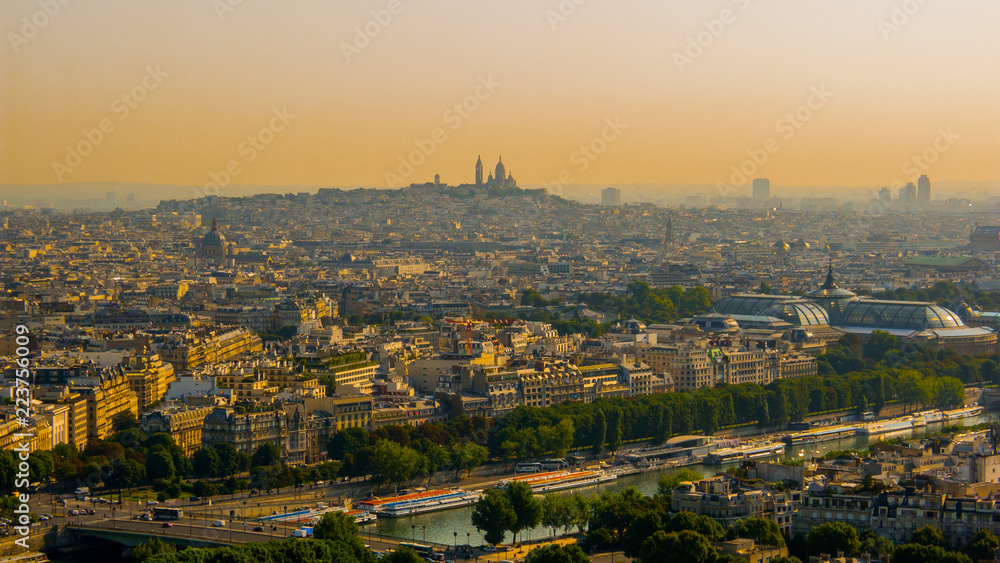 Fototapeta premium Beautiful view of the hill of Montmartre, the Sacré Coeur Basilica, the Central areas of Paris with the Eiffel tower in the morning colors