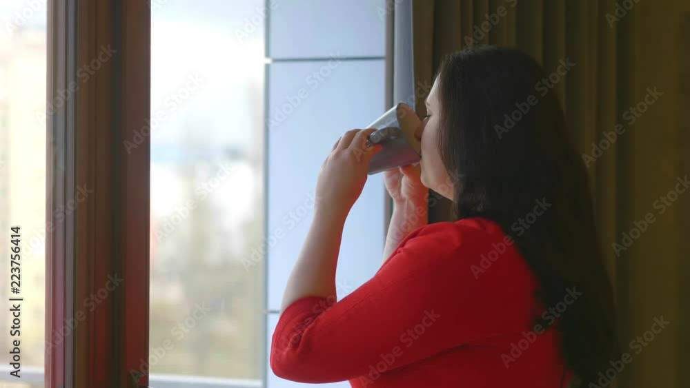 Beautiful romantic woman drinking hot tea or coffee in the morning in 4k slow motion 60fps Beautiful romantic woman drinking hot tea or coffee in the morning in 4k slow motion 60fps