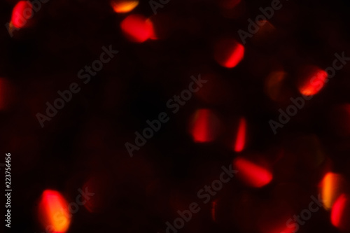 abstract lens flare on black background. red defocused lights. glowing blurred color burst. festive new year backdrop.