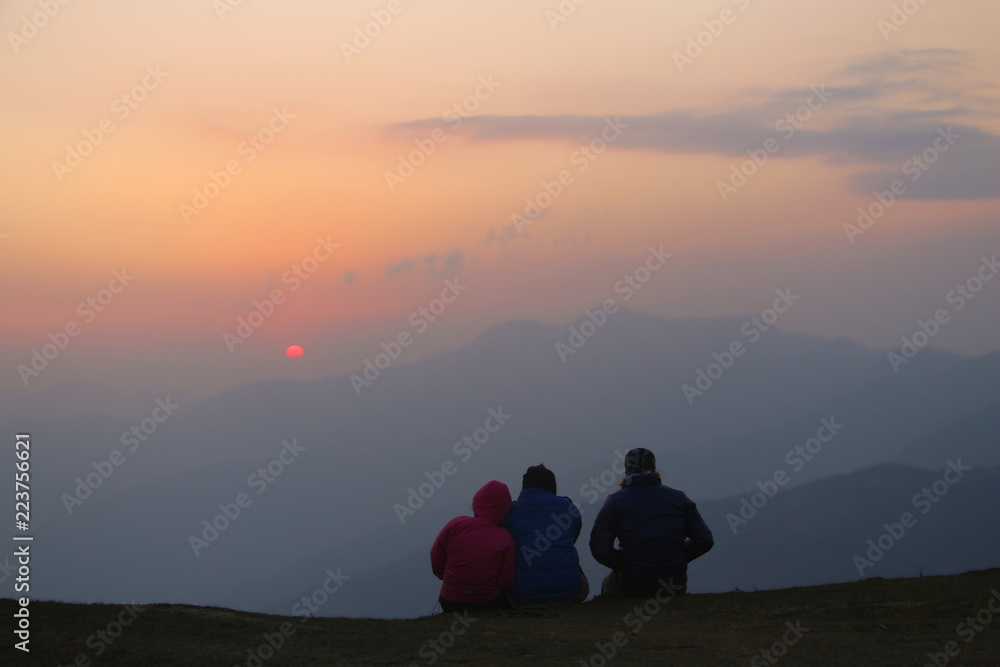 Group of people watching a sunset from mountain