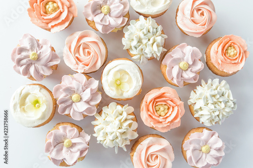 Mini cupcakes decorated with buttercream flowers. photo