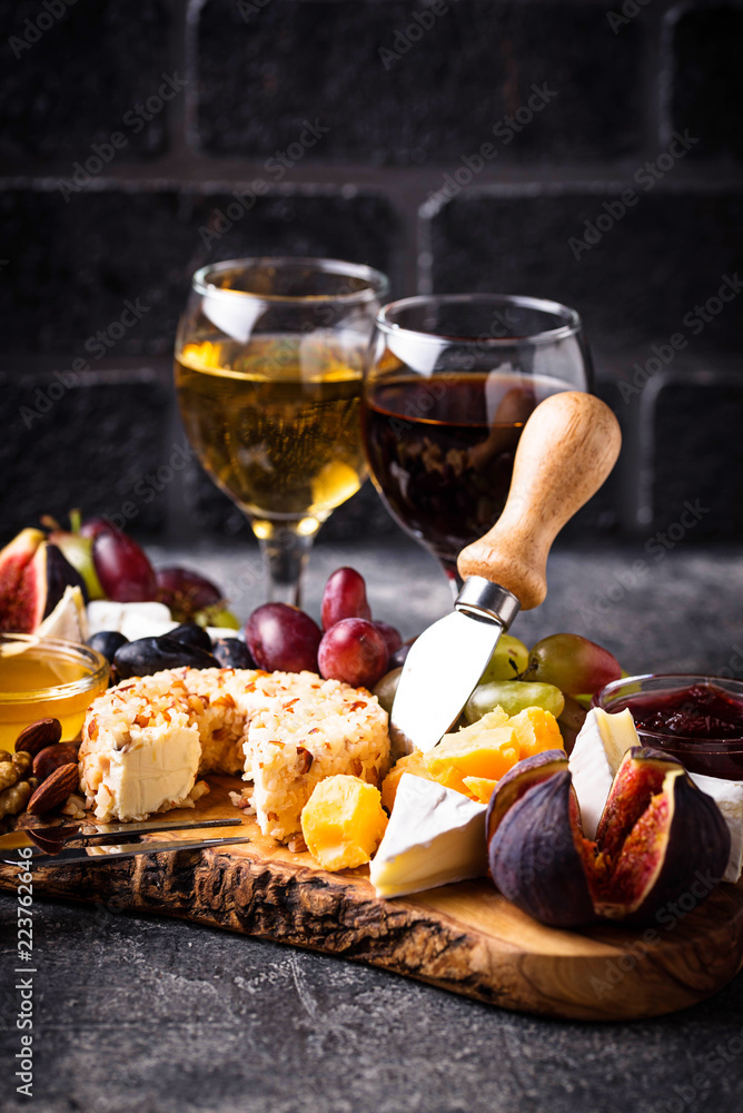 Cheese plate with grapes and wine