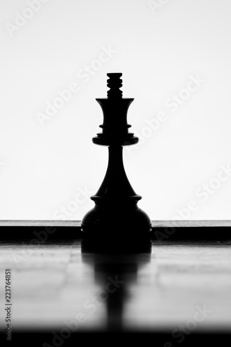 King chess piece silhouette on a white background