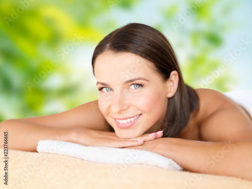 wellness  spa and beauty concept - close up of beautiful woman over green natural background