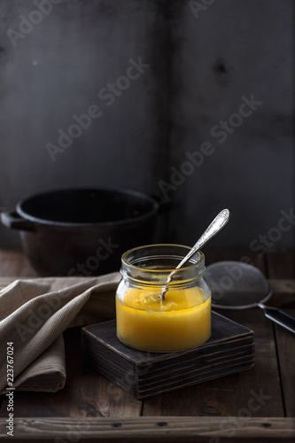 A jar of ghee or clarified butter, copy space photo