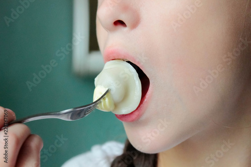 Photography Girl brings to her mouth meat dumpling on a fork